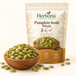 Herboria Pumpkin Seeds Whole 100g pouch with premium green pumpkin seeds in wooden bowl