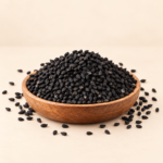 Premium quality Kalonji Nigella Seeds whole black seeds in wooden bowl on light cream background